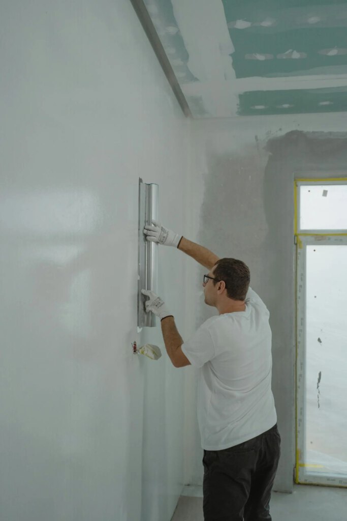 pexels-photo-6474135-6474135 A Man in White Shirt Painting a House